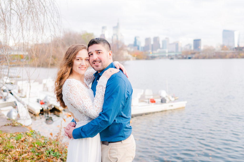Couple together posing for engagement photos by TM Grey Photo at Boathouse Row in Philadelphia.